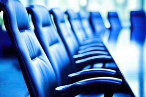 A row of blue leather chairs in a conference room photo