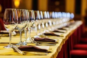 A long table with empty wine glasses photo