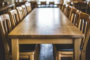 A long wooden table with chairs in front of it photo