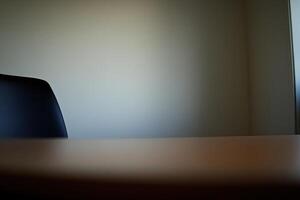 A black chair sits in front of a table photo