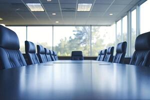 A conference table with black leather chairs in front of a large window photo