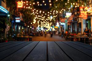 An empty wooden table in a city street at night photo