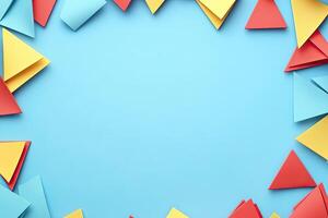 Colorful paper triangles on a blue background photo