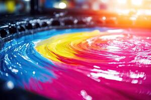 A large bowl of colorful ink is being poured into a machine photo