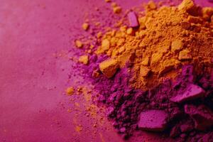 A pile of colorful powder on a pink background photo