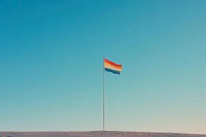 A flag flying in the air on a hill photo