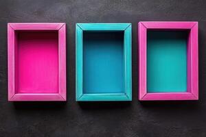 Three wooden boxes with different colors on a black background photo