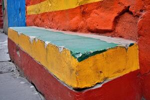 A colorful wall with a bench painted on it photo