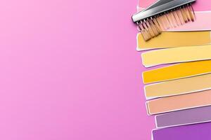 Color swatches and a comb on a pink background photo