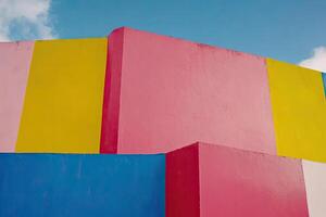 A colorful wall with a blue sky in the background photo
