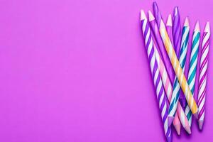 Many colorful pencils on a purple background photo