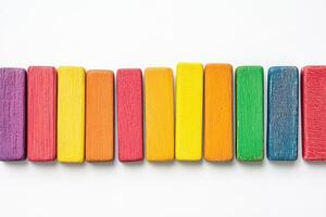 A row of colorful wooden blocks on a white background photo