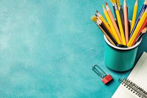 School supplies and pens on a blue background photo