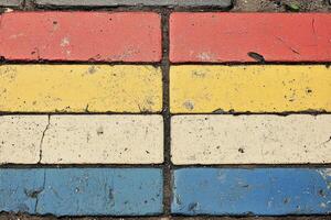 A red, yellow, blue, and white brick wall photo