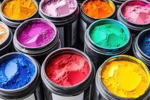 Many different colored paint cans are shown photo