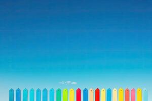 A colorful fence with a bench in the middle photo