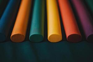 A row of colored pencils on a black background photo