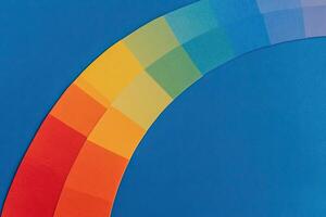 A rainbow colored circle on a blue background photo