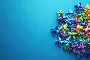 Colorful origami flowers on blue background photo