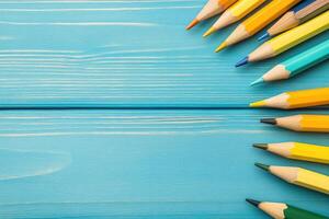 Colorful pencils on a blue wooden table photo