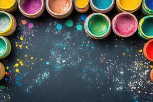 Colorful paint pots on a black background photo