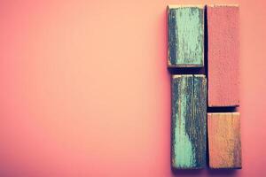 Colorful wooden blocks on a pink background photo