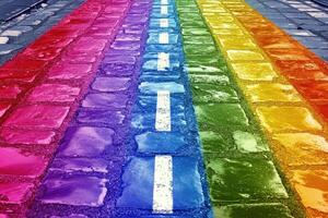 Rainbow road, a road with white lines painted on it photo