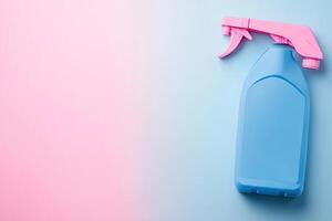 A blue spray bottle with pink sprayer on a pink and blue background photo