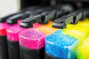 Colorful ink cartridges in a printer photo