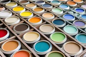 Paint cans are arranged in a wooden box photo
