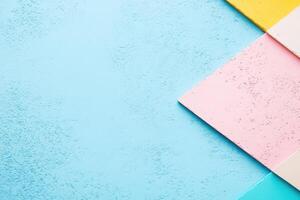 Colorful paper squares on a blue background photo