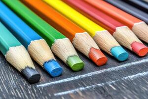 Colorful pencils on a blackboard photo