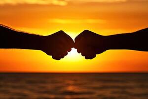 Silhouette fists at sunset photo