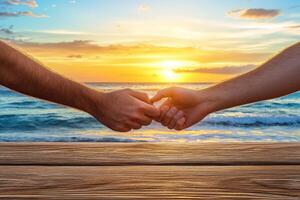 Two hands clasped, sunrise over ocean photo