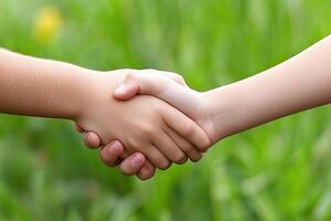 Children's hands shaking, friendship in nature photo