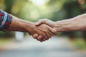 Two people shaking hands outdoors photo