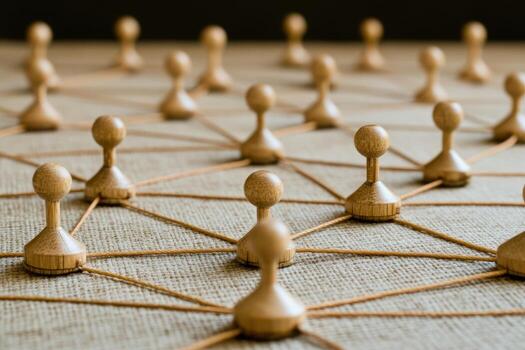 Network of interconnected individuals. Wooden figures connected by threads, creating a complex network photo