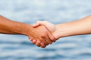 Two hands shaking. Close-up of a handshake photo