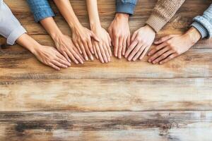 Hands of diverse people resting on a table, showing unity and togetherness photo