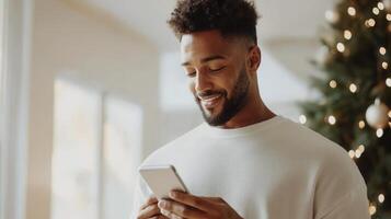 a in a white sweater uses a smartphone while standing by Man sunlit window, surrounded by soft curtains and indoor plants photo