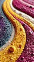 Colorful patterns created by vibrant liquid textures on a surface at close range showcasing different shades and droplets photo