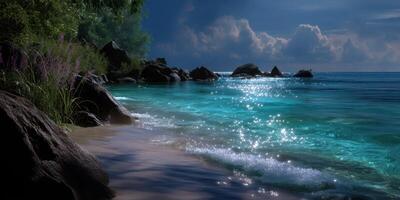 Serene beach at twilight with sparkling water and dramatic clouds along rocky shoreline photo