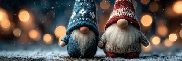 Two decorative gnomes wearing colorful knitted hats stand together in a snowy outdoor setting surrounded by soft, glowing lights photo