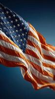Waving American flag against a deep blue background, symbolizing patriotism and national pride during a clear day photo