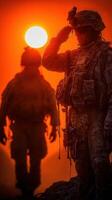 Soldiers saluting at sunset, showcasing camaraderie and respect in a mountainous landscape during military operations photo