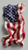 American flag draped elegantly on a gray background, showcasing its vibrant colors and star pattern in intricate detail photo