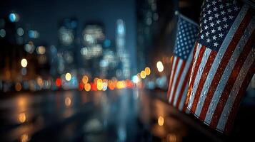 USA flags displayed on a wet street reflecting city lights during evening hours in an urban setting photo
