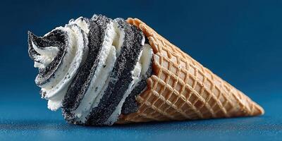 Unique black and white swirl ice cream cone sits on blue surface highlighting its delicious creamy texture and crispy cone photo