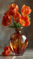 Vibrant orange tulips arranged in a glass vase for a bright floral display in a cozy indoor setting photo