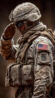Soldier saluting during a ceremonial event at a military base in a desert environment in the early morning light photo